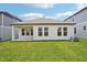 Expansive backyard with lush green grass and stylish exterior elevation of the home at 5290 Citrus Leaf Blvd, Winter Garden, FL 34787