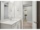 A bright bathroom with a white vanity and quartz countertop, offering a clean and modern design at 5290 Citrus Leaf Blvd, Winter Garden, FL 34787