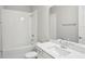 This bathroom offers a sink and vanity with white quartz counters, plus a tub with a shower at 5290 Citrus Leaf Blvd, Winter Garden, FL 34787