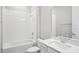 Well-lit bathroom featuring a shower-tub combo and sleek, modern fixtures at 5290 Citrus Leaf Blvd, Winter Garden, FL 34787