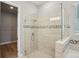 Modern bathroom showcases a glass shower, tile accents, and access to a walk-in closet at 5290 Citrus Leaf Blvd, Winter Garden, FL 34787