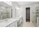 Modern bathroom featuring double sinks, spacious vanities and glass enclosed shower at 5290 Citrus Leaf Blvd, Winter Garden, FL 34787