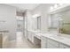 Bright primary bathroom with dual sinks, vanities, tile work, and a glass-enclosed shower at 5290 Citrus Leaf Blvd, Winter Garden, FL 34787