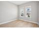 Bright bedroom with hardwood floors and two windows offering plenty of natural light at 5290 Citrus Leaf Blvd, Winter Garden, FL 34787