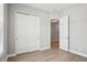 Cozy bedroom with a closet and an open doorway, showcasing modern flooring at 5290 Citrus Leaf Blvd, Winter Garden, FL 34787
