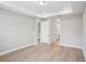 Bright bedroom with tray ceiling, opening to the ensuite bathroom at 5290 Citrus Leaf Blvd, Winter Garden, FL 34787