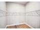 Spacious walk-in closet with ample shelving and wood flooring for organized storage at 5290 Citrus Leaf Blvd, Winter Garden, FL 34787