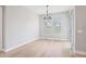 Dining room with hardwood floors, elegant chandelier, and access to the outdoor patio at 5290 Citrus Leaf Blvd, Winter Garden, FL 34787