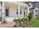 Inviting covered front porch with stone accents and meticulously landscaped front yard at 5290 Citrus Leaf Blvd, Winter Garden, FL 34787