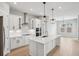Modern kitchen with stainless steel appliances, large island, and stylish pendant lighting at 5290 Citrus Leaf Blvd, Winter Garden, FL 34787