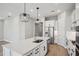 Open concept kitchen with a large center island, stainless appliances and stylish pendant lighting at 5290 Citrus Leaf Blvd, Winter Garden, FL 34787