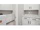 Well-equipped laundry room with modern appliances, ample storage, and a sink at 5290 Citrus Leaf Blvd, Winter Garden, FL 34787