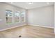 Bright and airy living room featuring hardwood floors and three large windows at 5290 Citrus Leaf Blvd, Winter Garden, FL 34787