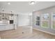 Open-concept living space with hardwood floors, seamlessly connecting the kitchen and living areas at 5290 Citrus Leaf Blvd, Winter Garden, FL 34787