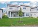 New construction home backyard featuring a lawn, covered patio, and a young tree freshly planted at 5307 Citrus Leaf Blvd, Winter Garden, FL 34787