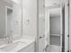 Bright bathroom featuring a single vanity, a mirror, and a doorway leading into the bedroom at 5307 Citrus Leaf Blvd, Winter Garden, FL 34787