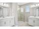 Bright bathroom featuring double vanity sinks, a glass-enclosed shower, and modern fixtures at 5307 Citrus Leaf Blvd, Winter Garden, FL 34787