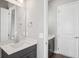 Stylish bathroom with a dark vanity, white countertop, and modern fixtures at 5307 Citrus Leaf Blvd, Winter Garden, FL 34787
