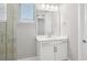 A modern bathroom showcasing a sleek vanity, mirror, a glass-enclosed shower, and natural light at 5307 Citrus Leaf Blvd, Winter Garden, FL 34787