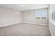 Bright and spacious carpeted bedroom featuring a large window with neighborhood views at 5307 Citrus Leaf Blvd, Winter Garden, FL 34787
