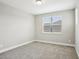 Cozy bedroom with neutral carpeting and natural light from a window, ideal for relaxation at 5307 Citrus Leaf Blvd, Winter Garden, FL 34787