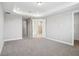 Large bedroom with neutral carpet and doorways leading to the bathroom and hallways at 5307 Citrus Leaf Blvd, Winter Garden, FL 34787
