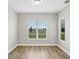 Serene bedroom featuring wood floors, bright windows, and a picturesque view of the outdoors at 5307 Citrus Leaf Blvd, Winter Garden, FL 34787