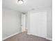 A simple bedroom has an adjacent doorway and a closet with bifold doors at 5307 Citrus Leaf Blvd, Winter Garden, FL 34787