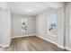 Bright bedroom with wood-look flooring and natural light from two windows at 5307 Citrus Leaf Blvd, Winter Garden, FL 34787