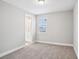 Bright bedroom featuring neutral walls, carpet, and an adjacent bathroom with a vanity and sink at 5307 Citrus Leaf Blvd, Winter Garden, FL 34787