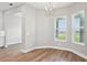 Bright dining room featuring wood floors, modern lighting, and scenic views from large windows at 5307 Citrus Leaf Blvd, Winter Garden, FL 34787