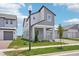 This modern two-story home boasts a covered porch and landscaped front yard at 5307 Citrus Leaf Blvd, Winter Garden, FL 34787