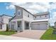 Charming modern two-story home featuring a brick driveway and covered porch with metal railing at 5307 Citrus Leaf Blvd, Winter Garden, FL 34787