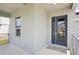 Covered porch showing a modern glass front door and metal railing at 5307 Citrus Leaf Blvd, Winter Garden, FL 34787