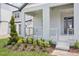 Inviting covered front porch with modern metal railing and landscaped garden at 5307 Citrus Leaf Blvd, Winter Garden, FL 34787