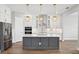 Bright kitchen with stainless steel appliances, custom cabinets, and a marble-topped island at 5307 Citrus Leaf Blvd, Winter Garden, FL 34787