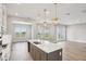 Spacious kitchen with stainless steel appliances, a large island, and an open view to the living area at 5307 Citrus Leaf Blvd, Winter Garden, FL 34787