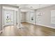 Airy living room with lots of natural light, sleek floors, and access to the entry of the house at 5307 Citrus Leaf Blvd, Winter Garden, FL 34787