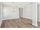 Open-concept living room with wood floors and modern chandelier at 5307 Citrus Leaf Blvd, Winter Garden, FL 34787