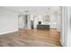 Open floorplan with hardwood floors, kitchen island, stainless steel appliances, and a staircase at 5307 Citrus Leaf Blvd, Winter Garden, FL 34787