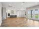 Expansive open floorplan with hardwood floors, kitchen island, stainless appliances, and natural light at 5307 Citrus Leaf Blvd, Winter Garden, FL 34787