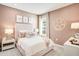 Charming pink bedroom featuring a comfortable bed, stylish decor, and plenty of natural light at 545 Moon Shell Cir, New Smyrna Beach, FL 32168