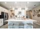 Modern kitchen with a large white island, stainless steel appliances, and pendant lighting, perfect for entertaining at 545 Moon Shell Cir, New Smyrna Beach, FL 32168