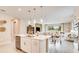 Open-concept kitchen with stainless steel appliances, island with seating and view of living room at 545 Moon Shell Cir, New Smyrna Beach, FL 32168