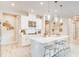 Modern kitchen with a large white island, stainless steel appliances, and pendant lighting, perfect for entertaining at 545 Moon Shell Cir, New Smyrna Beach, FL 32168