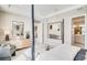Bright primary bedroom with large windows, ensuite bathroom, and a comfortable seating area at 545 Moon Shell Cir, New Smyrna Beach, FL 32168