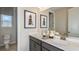 Modern bathroom featuring double sinks, stylish mirrors, and bright lighting at 548 Moon Shell Cir, New Smyrna Beach, FL 32168