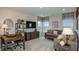 Cozy living room with stylish furniture, a desk, and abundant natural light at 548 Moon Shell Cir, New Smyrna Beach, FL 32168