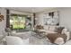 Inviting living room with a cozy sofa, area rug, sliding glass doors to a patio and backyard at 548 Moon Shell Cir, New Smyrna Beach, FL 32168
