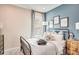Stylish bedroom with iron bed frame, cozy bedding, modern lamp and artwork at 553 Moon Shell Cir, New Smyrna Beach, FL 32168
